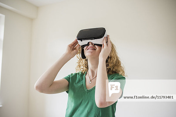 Woman wearing VR glasses looking up