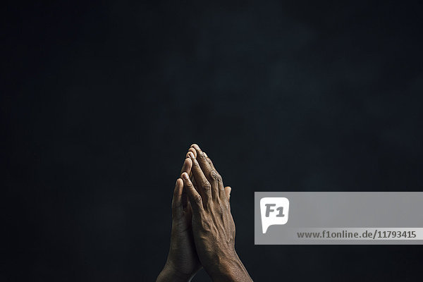 Hands of man and black background