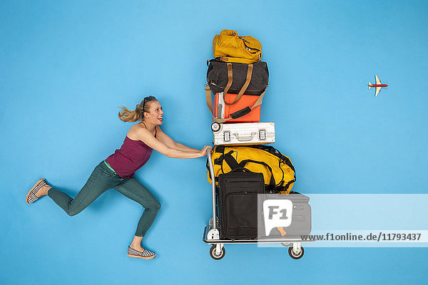 Woman pushing luggage trolley