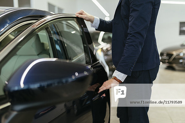 Customer looking at car in car dealership