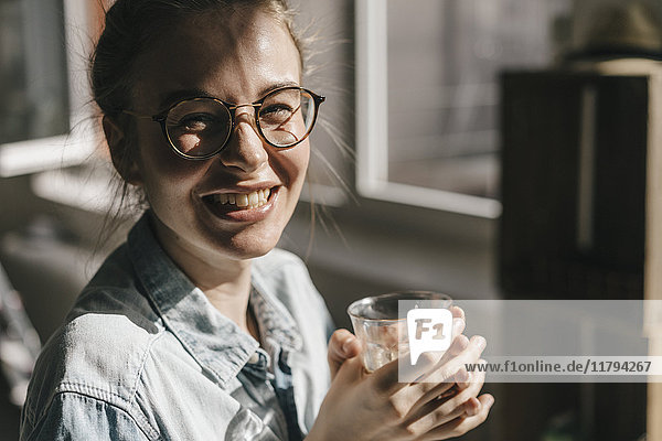 Portrait of happy young woman with glasses