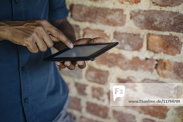 Close-up of businessman using tablet