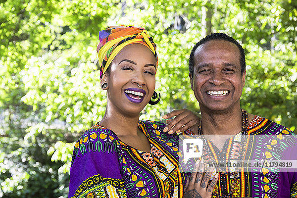 Portrait of laughing young woman and her father wearing traditional Brazilian clothing