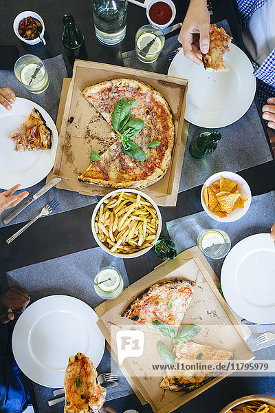 Friends having pizza and French fries