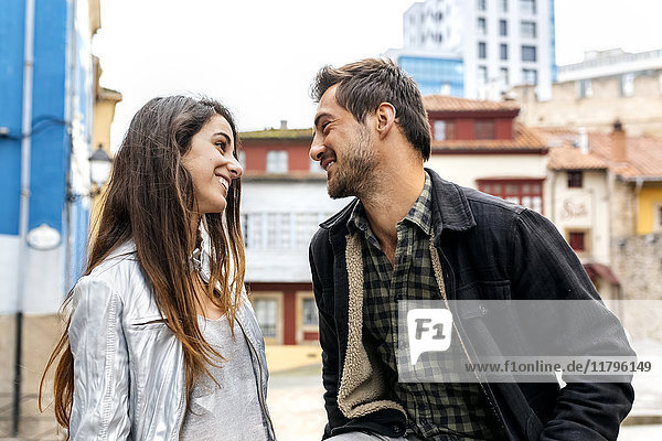 Couple smiling at each other in the city