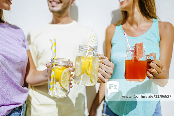 Close-up of friends holding refreshing drinks