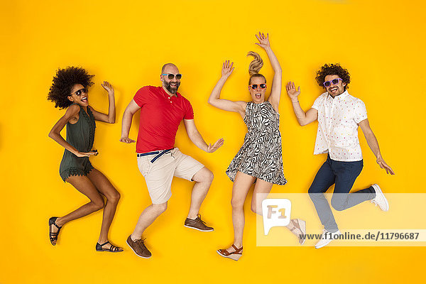 Group of people wearing sunglasses  dancing happily