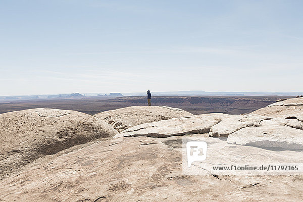 Man standing at overlook at Muley Point  San Juan Canyon in distance  Bears Ears National Monument  Utah