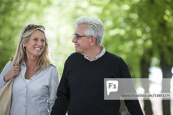 Mature couple walking in park