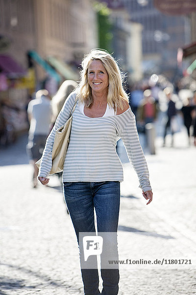 Blond woman walking on street
