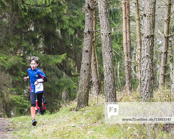 Boy running in forest