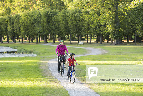 Mother and son cycling in park