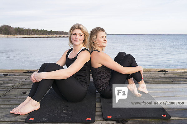 Women sitting on pier