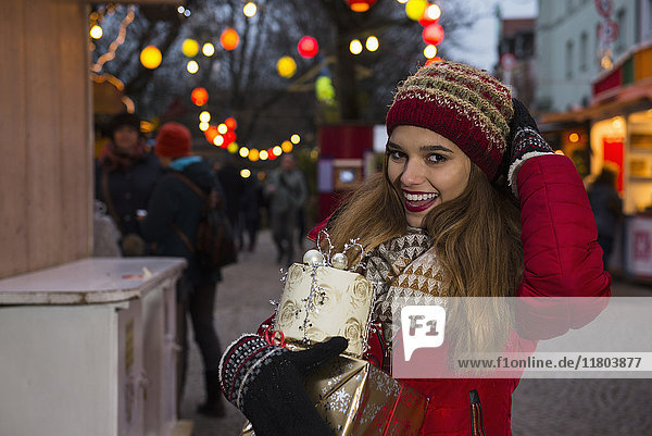 Portrait of young woman with Christmas gift