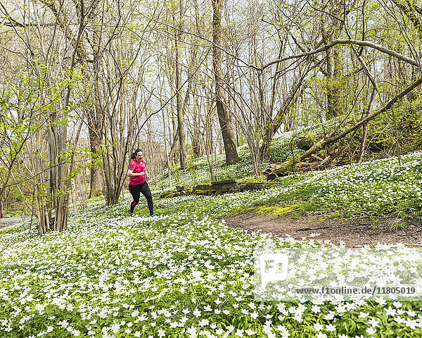 Woman running in spring forest