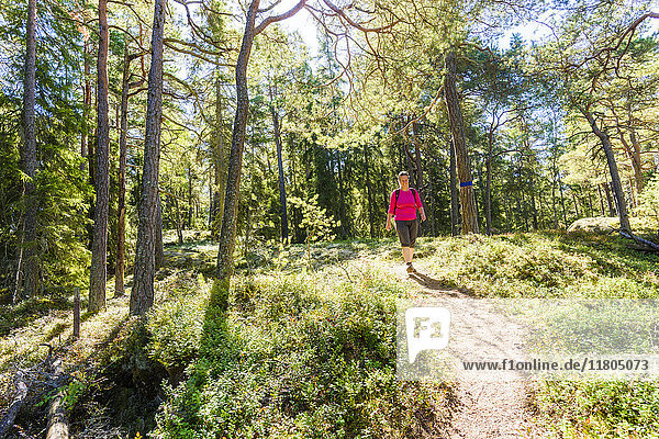 Woman walking through forest