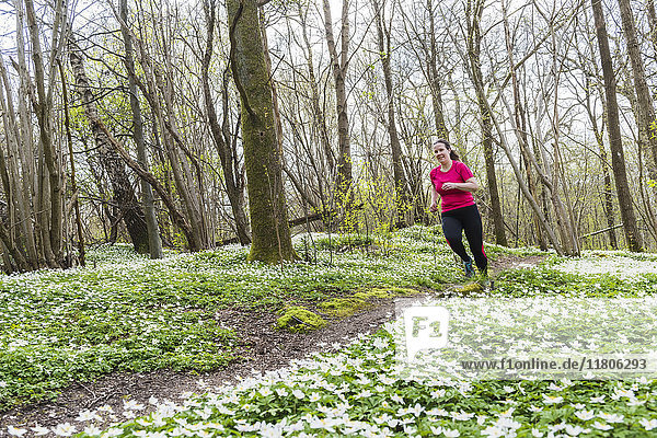 Woman running in spring forest