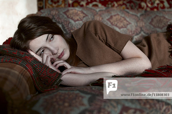 Caucasian woman laying on sofa