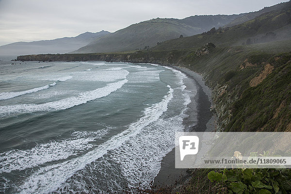 Scenic view of ocean beach and cliffs