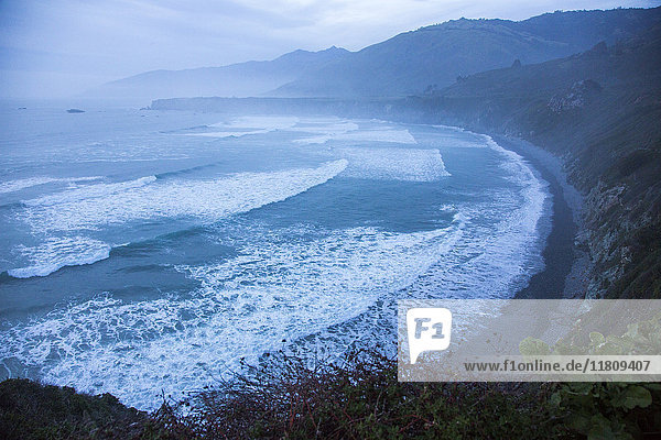Scenic view of ocean beach and cliffs