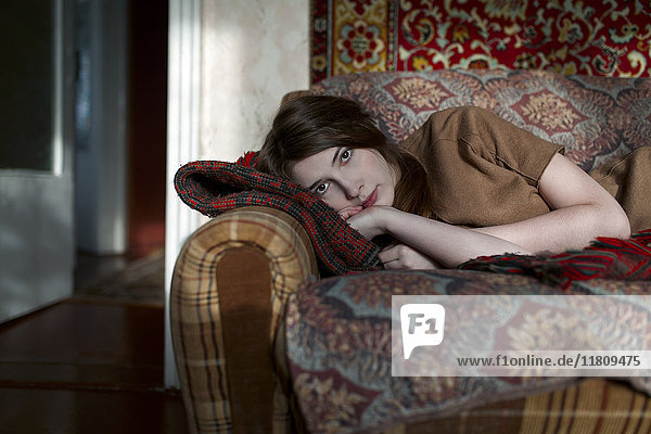 Caucasian woman laying on sofa