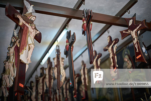 Crucifixes handing on beams in shop