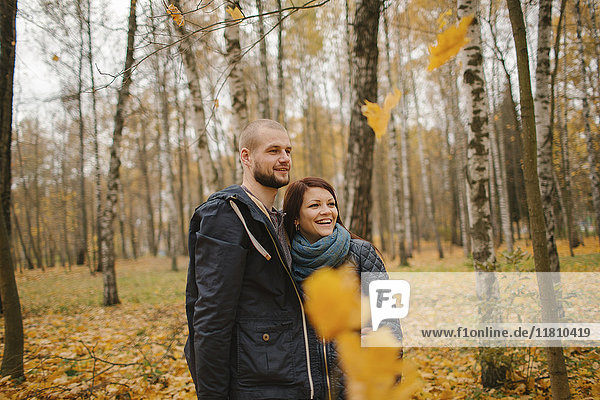 Middle Eastern couple standing in park in autumn