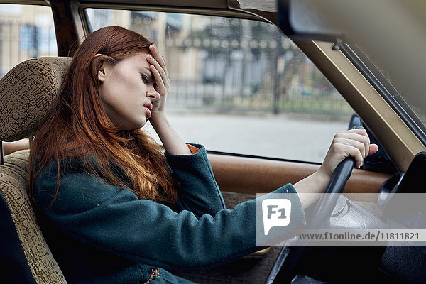 Frustrated Caucasian woman driving car