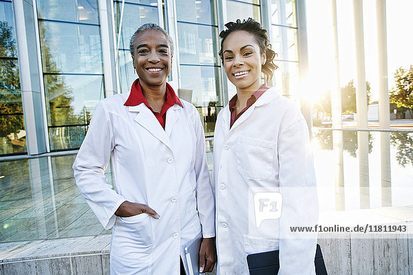 Portrait of smiling doctors outdoors at hospital