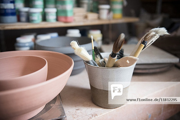 Pottery brushes and bowls in workshop