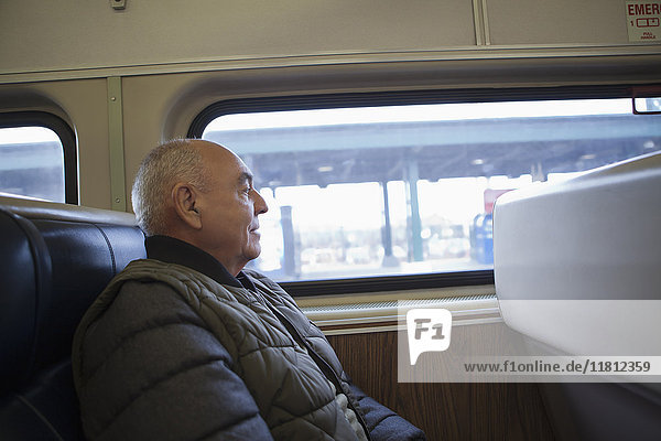 Hispanic man sitting on train