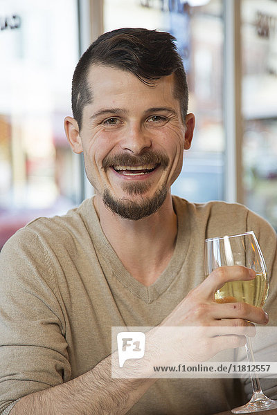 Portrait of Caucasian man drinking white wine