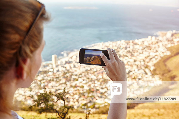 Young woman on mountain  photographing view  Lions Head Mountain  Western Cape  Cape Town  South Africa  Africa
