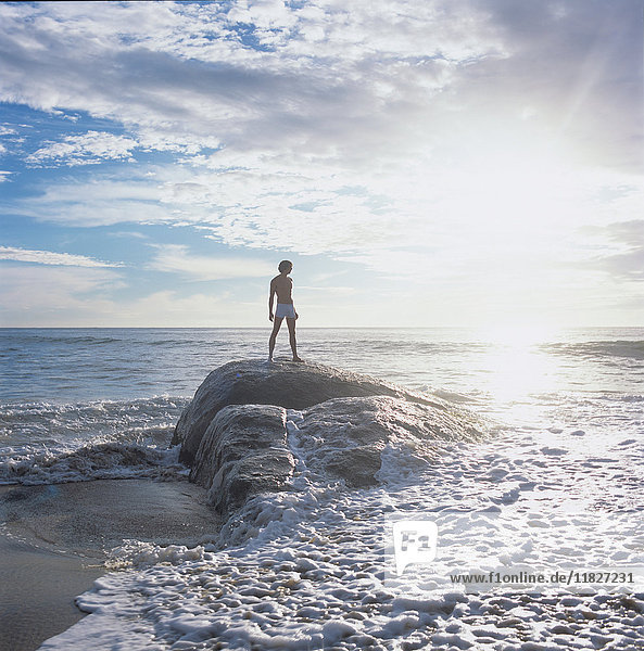 Man standing on rock in sea looking away  China Bay  Sri Lanka  Asia