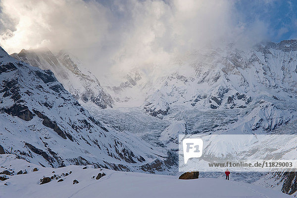 Hiker in snowy mountain landscape