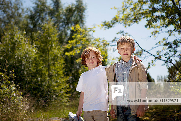 Smiling children hugging outdoors