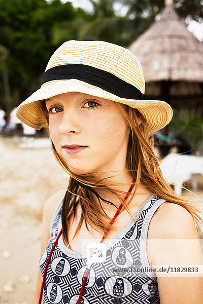 Girl wearing straw hat on beach