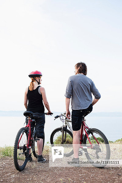 Couple with bikes enjoying view