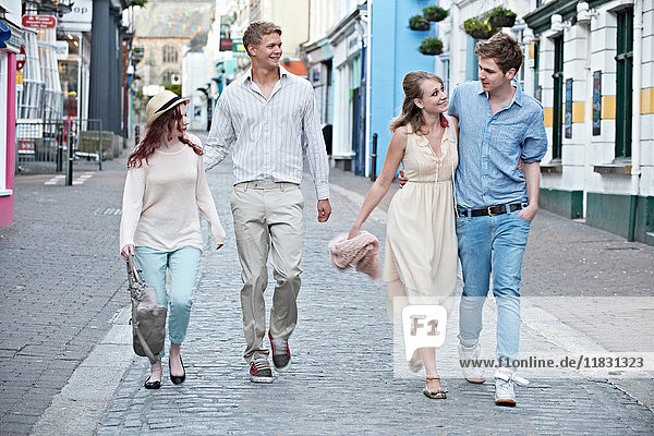 Couples walking together on city street