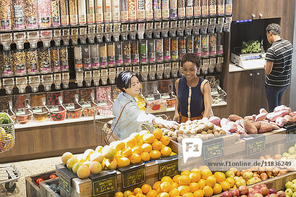 Young women grocery shopping  browsing produce in market