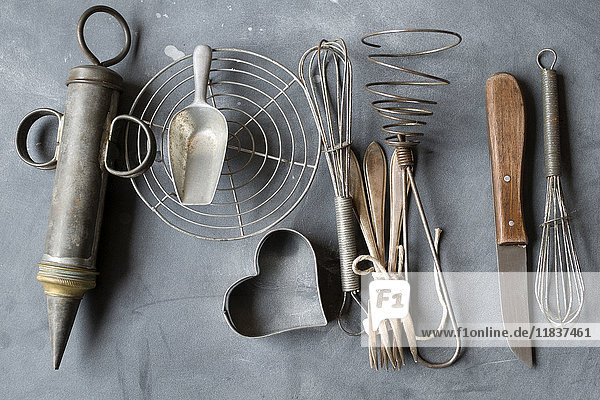 Group of vintage cooking utensils on gray background