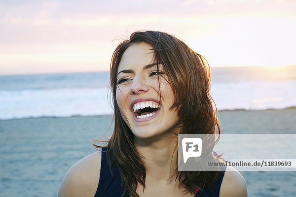 Portrait of laughing Caucasian woman at beach