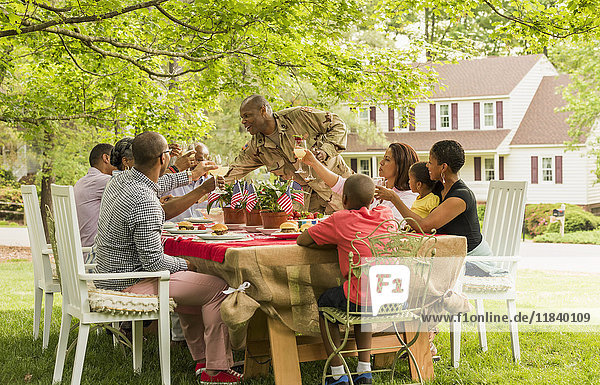 Multi-generation family toasting with lemonade at picnic