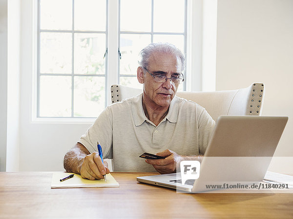 Caucasian man online shopping on laptop