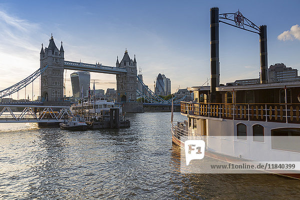 Tower Bridge  traditional riverboat and City of London skyline from Butler's Wharf  London  England  United Kingdom  Europe
