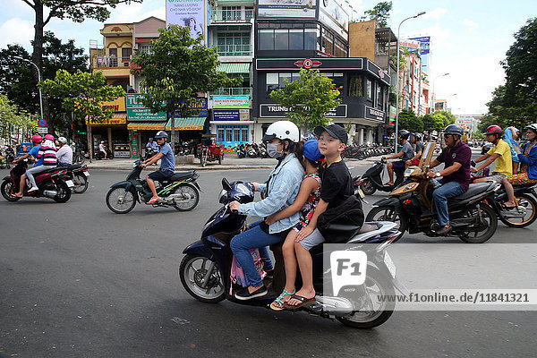 Mother and children on motor scooter on Saigon Street  Ho Chi Minh City  Vietnam  Indochina  Southeast Asia  Asia