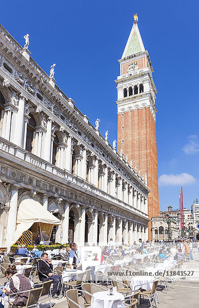Campanile tower  Piazzetta  and tourists enjoying the cafes of St. Marks Square  Venice  UNESCO World Heritage Site  Veneto  Italy  Europe