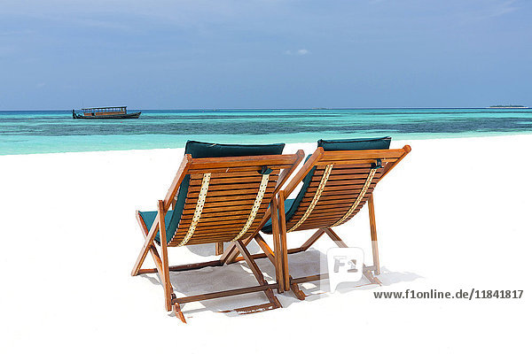 Wooden sun loungers on beach Coco Palm Dhuni Kolhu Baa Atoll Republic of Maldives Indian Ocean Asia