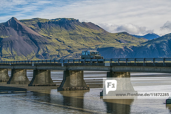 Fahrzeug fährt über eine Brücke an der Südküste von Island; Island'.
