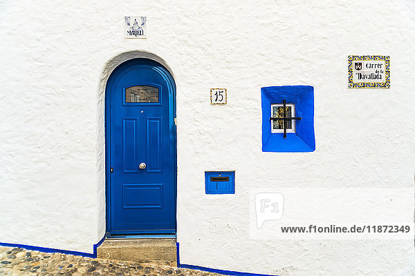 'Traditional house with the classical Mediterranean colours white walls and blue windows and doors; Sitges Barcelona province Spain'